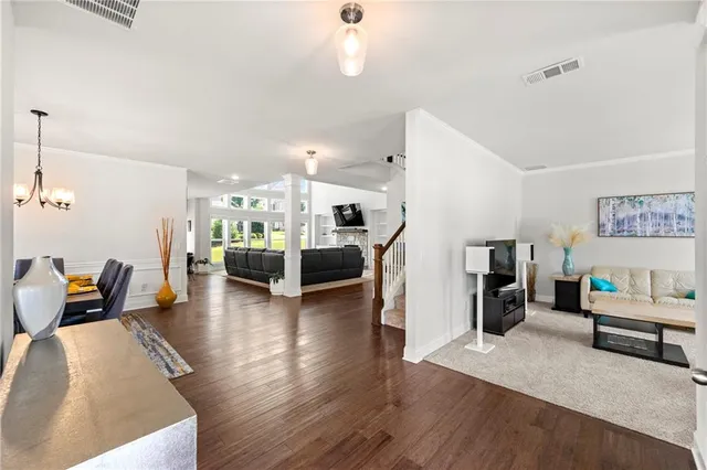 a living room with furniture and kitchen view