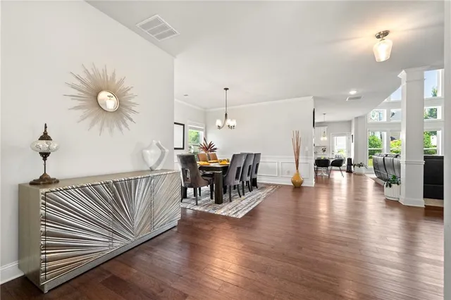 a view of a dining room with furniture wooden floor and chandelier