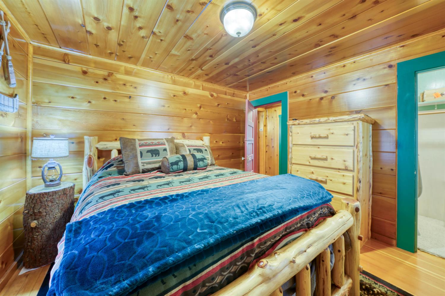 42025 Tollhouse Road Shaver Lake, CA 93664 - Photo 41 of 64 a bed sitting in a bedroom next to a window