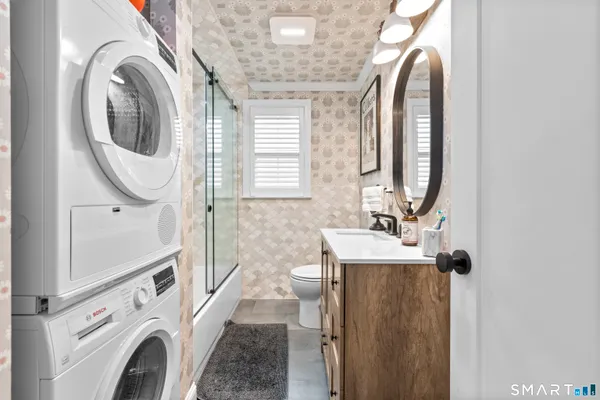 a view of a bathroom with washing machine and sink