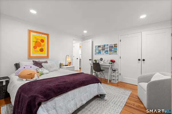 a bedroom with a bed and a couch