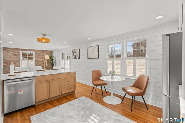 a view of a dining room with furniture and wooden floor