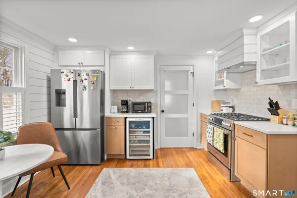 a kitchen with stainless steel appliances granite countertop a refrigerator stove and sink