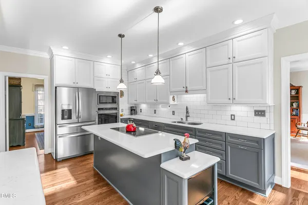a living room with kitchen island furniture and a chandelier