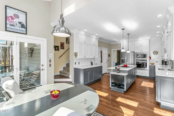 a living room with furniture and floor to ceiling windows
