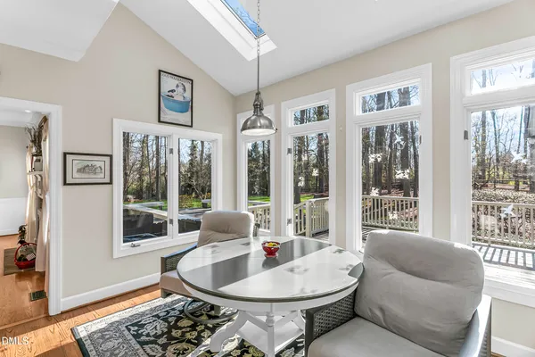 a living room with furniture a fireplace and a large window