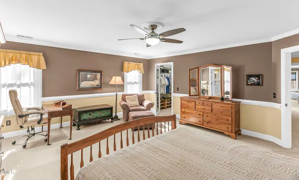 a bedroom with two beds and a couch