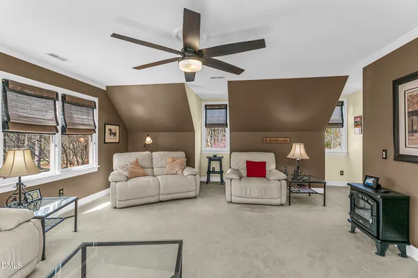 a backyard of a house with plants and wooden fence