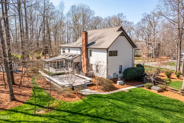a view of a house with backyard and sitting area