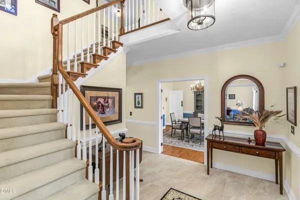a kitchen with stainless steel appliances granite countertop a sink a stove and white cabinets with wooden floor