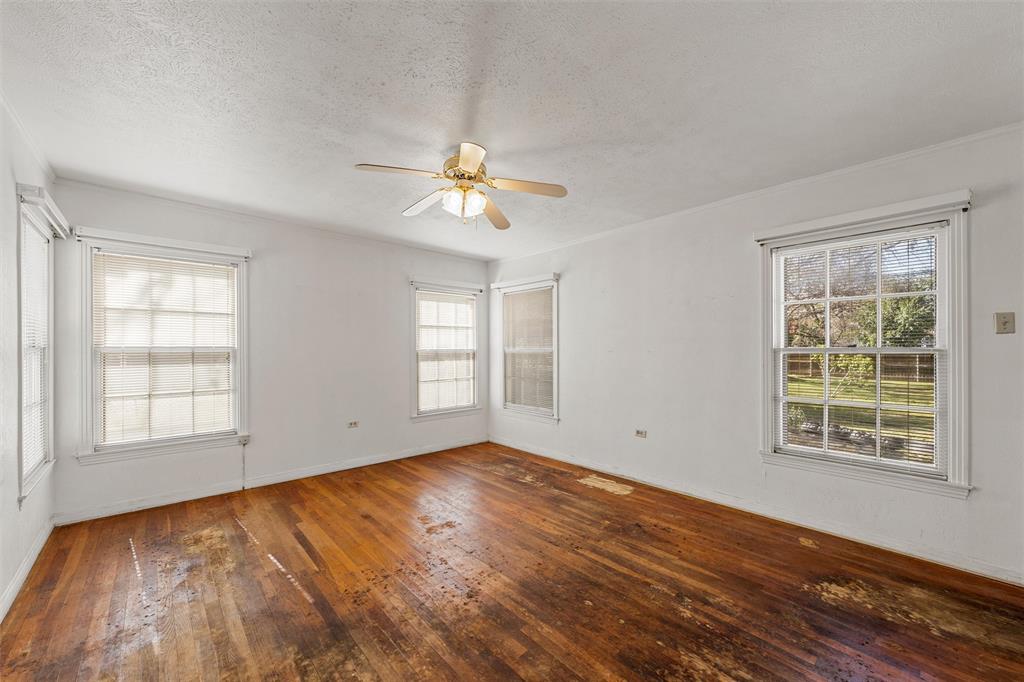 3117 Colcord Avenue Waco, TX 76707 - Photo 13 of 26 an empty room with wooden floor and windows