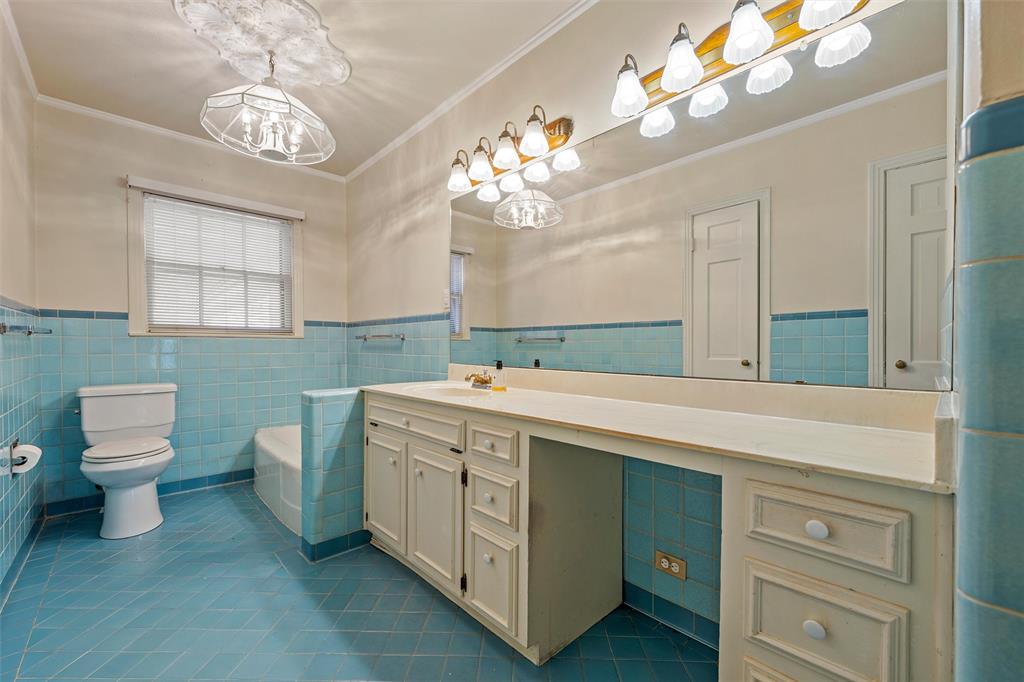 3117 Colcord Avenue Waco, TX 76707 - Photo 15 of 26 a bathroom with a sink mirror and a toilet