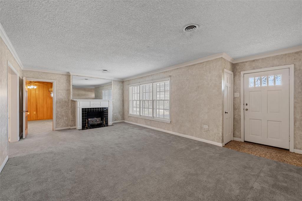 3117 Colcord Avenue Waco, TX 76707 - Photo 3 of 26 a view of an empty room with a fireplace and a window
