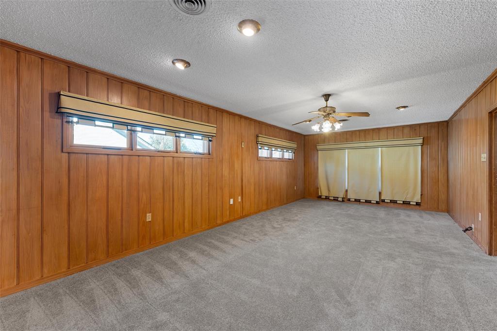 3117 Colcord Avenue Waco, TX 76707 - Photo 9 of 26 a view of an empty room with windows and chandelier fan