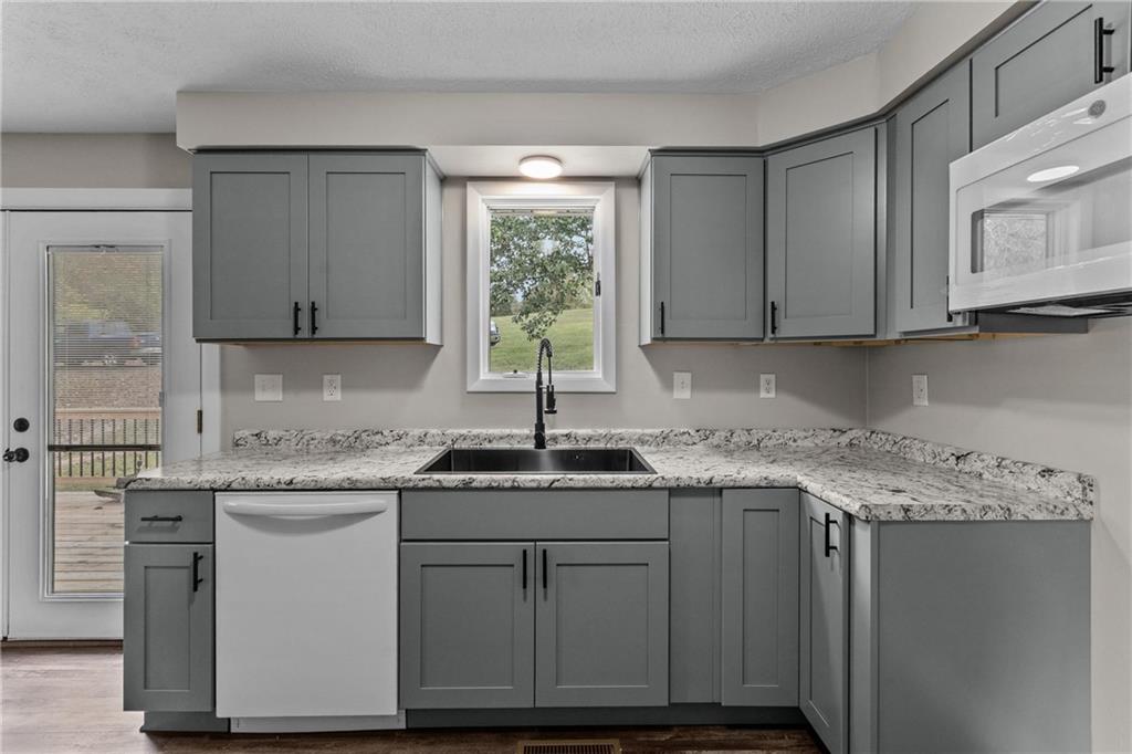 7440 Noblestown Road McDonald, PA 15057 - Photo 9 of 38 a kitchen with stainless steel appliances granite countertop a sink stove and cabinets