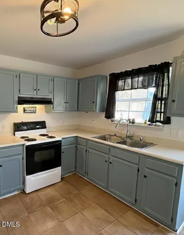 a kitchen with cabinets and stainless steel appliances