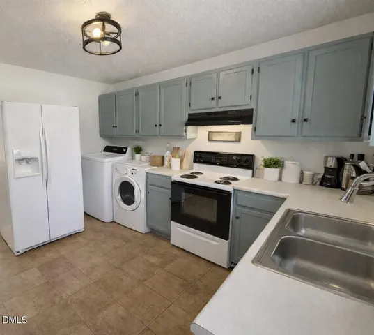 a kitchen with cabinets appliances and a sink