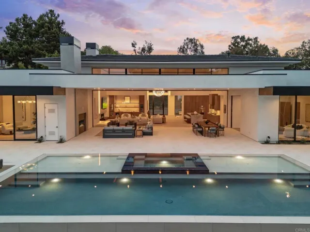 a view of swimming pool with outdoor seating and a lots of car in front of it