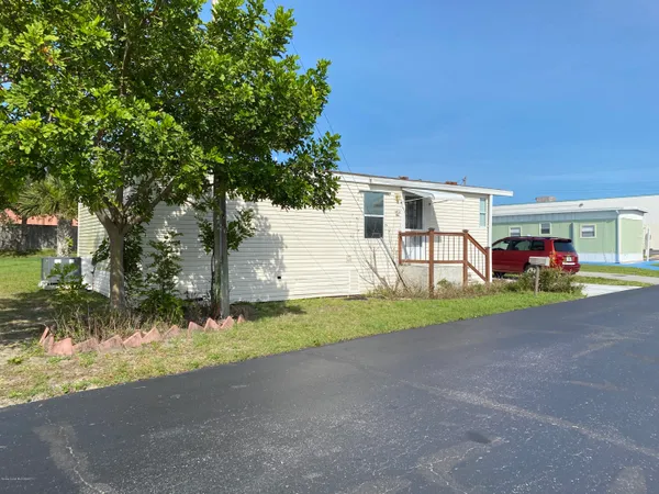 a view of a house with a yard and garage