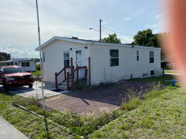 a view of a house with a yard and garage