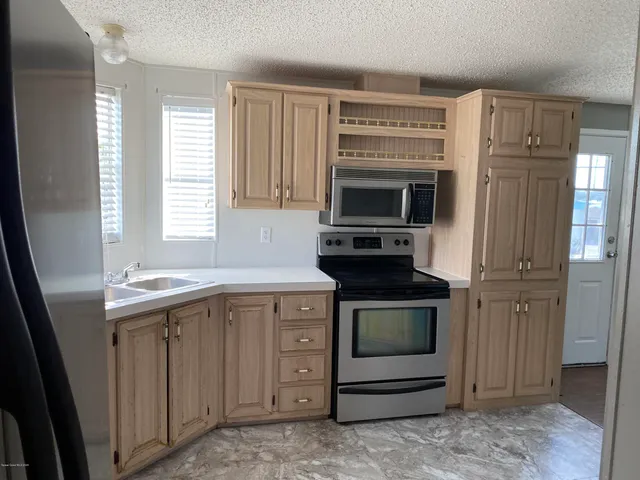a kitchen with a stove and a microwave