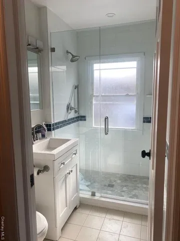 a bathroom with a double vanity sink and mirror