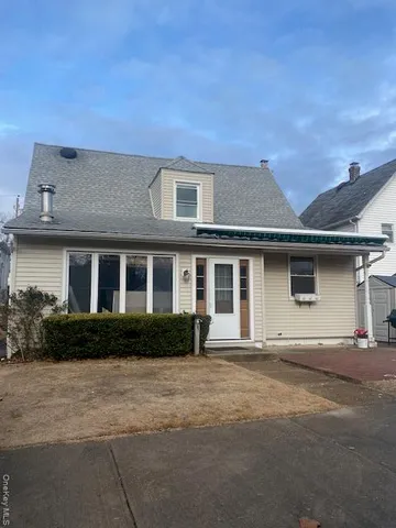 a front view of a house with yard and green space