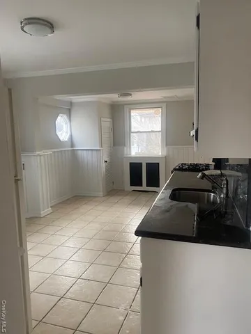 a kitchen with a sink and a stove top oven