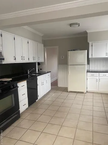 a kitchen with cabinets and appliances