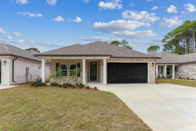 a front view of a house with yard and outdoor seating