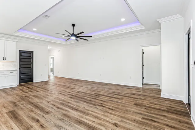 a view of a kitchen with wooden floor a sink and dishwasher