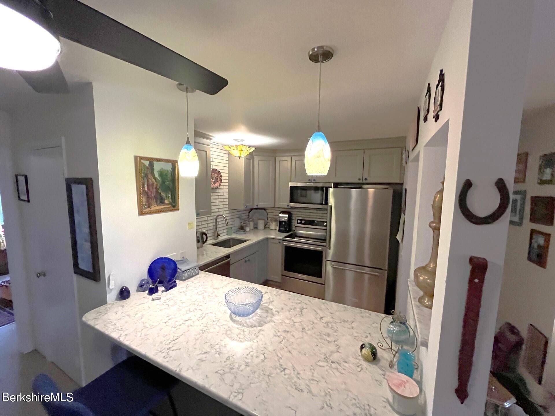 260 Pittsfield Road, Unit F17 Lenox, MA 01240 - Photo 12 of 33 Bar to Kitchen