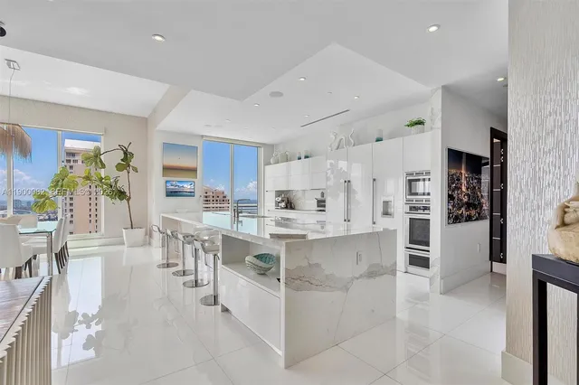 a view of a ocean with boats and trees in the background