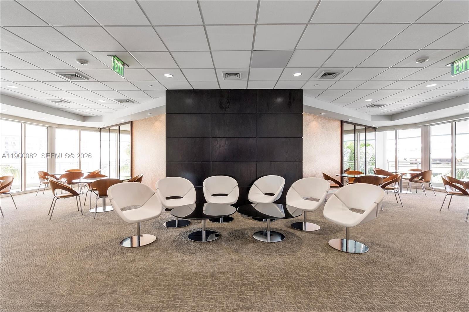 900 Brickell Key Boulevard, Unit 3103 Miami, FL 33131 - Photo 48 of 54 a living room with furniture a table and white walls