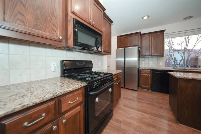 a kitchen with a sink stove and refrigerator
