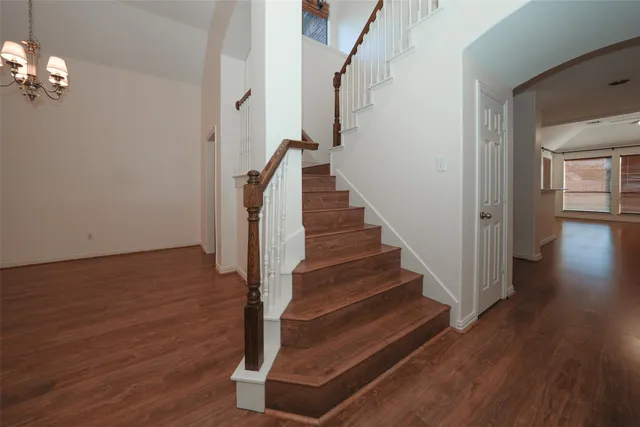 a view of entryway and hall with wooden floor