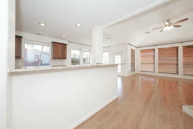 a view of a kitchen with wooden floor and a kitchen