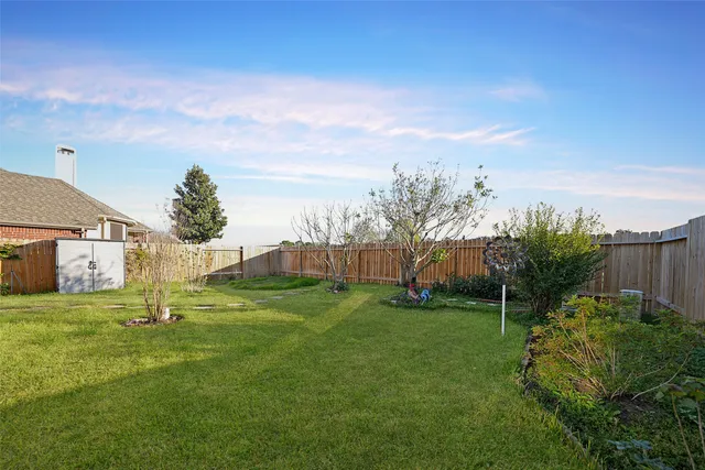 a garden with trees in front of it