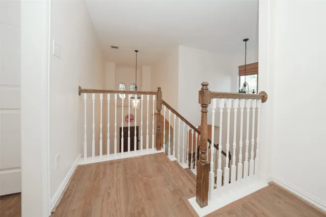 an empty room with wooden floor and closet