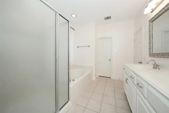 a bathroom with a sink a mirror and a bathtub