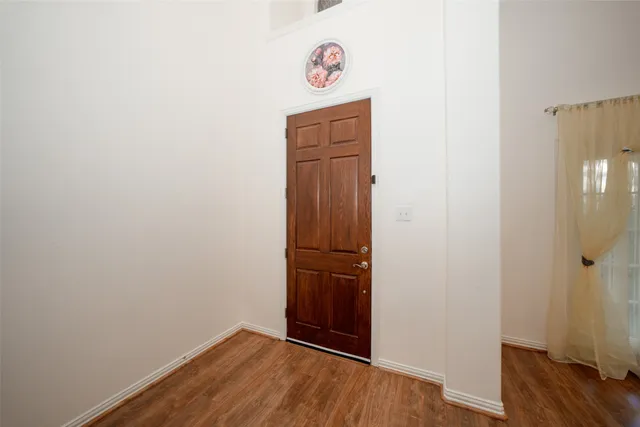 an empty room with wooden floor