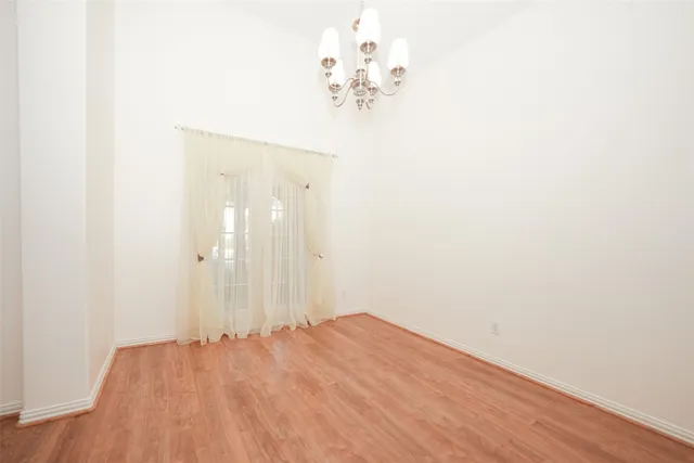 a view of a room with wooden floor