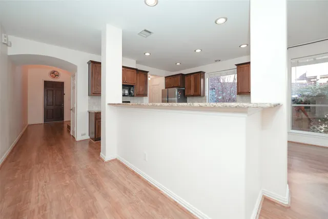 a kitchen with stainless steel appliances a refrigerator and a stove top oven