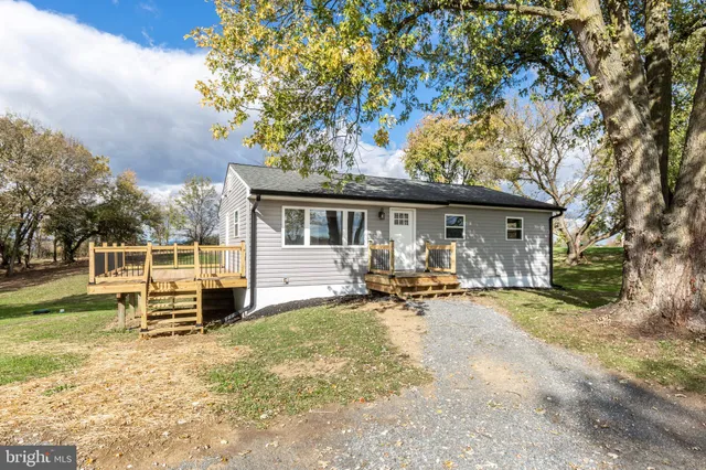 a view of a house with backyard porch and sitting area
