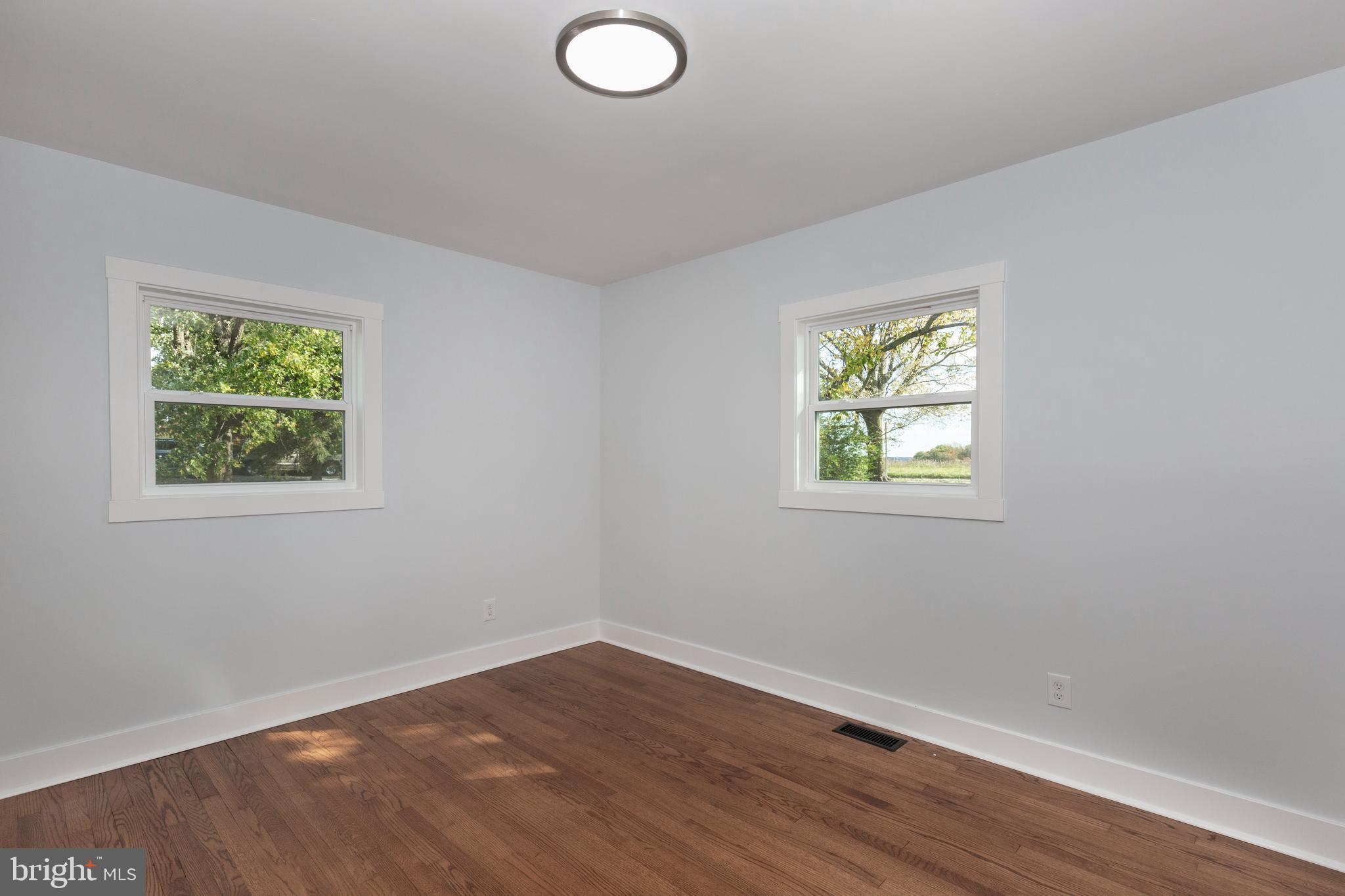 1030 Mckinstrys Mill Road Union Bridge, MD 21791 - Photo 12 of 43 an empty room with wooden floor and windows