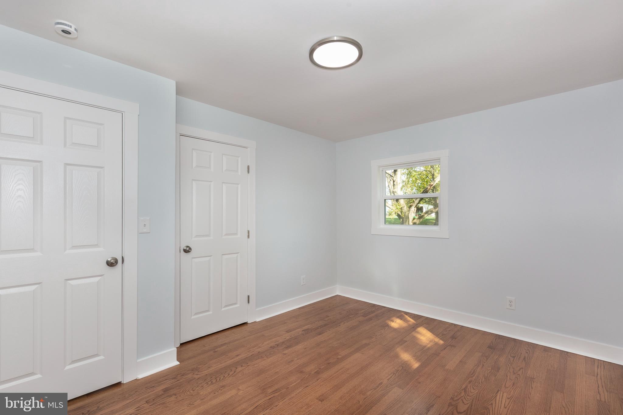 1030 Mckinstrys Mill Road Union Bridge, MD 21791 - Photo 13 of 43 a view of an empty room with wooden floor and a window