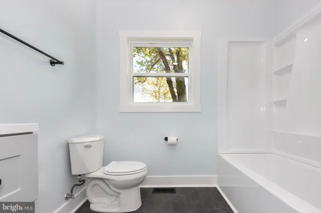 a bathroom with a toilet a sink and a bathtub