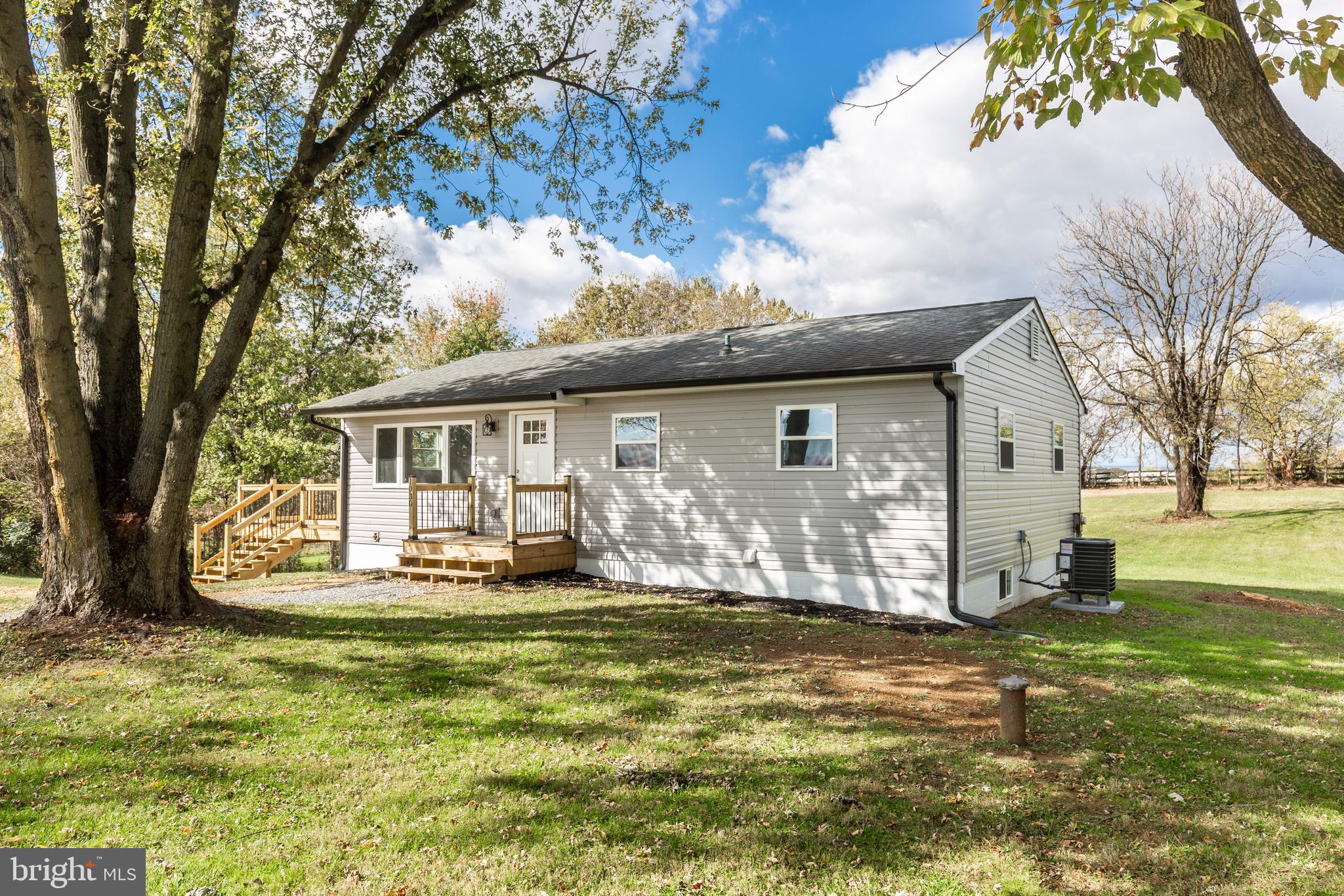 1030 Mckinstrys Mill Road Union Bridge, MD 21791 - Photo 2 of 43 a front view of a house with a garden and tree