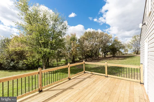 a view of a balcony with floor to ceiling window and wooden fence