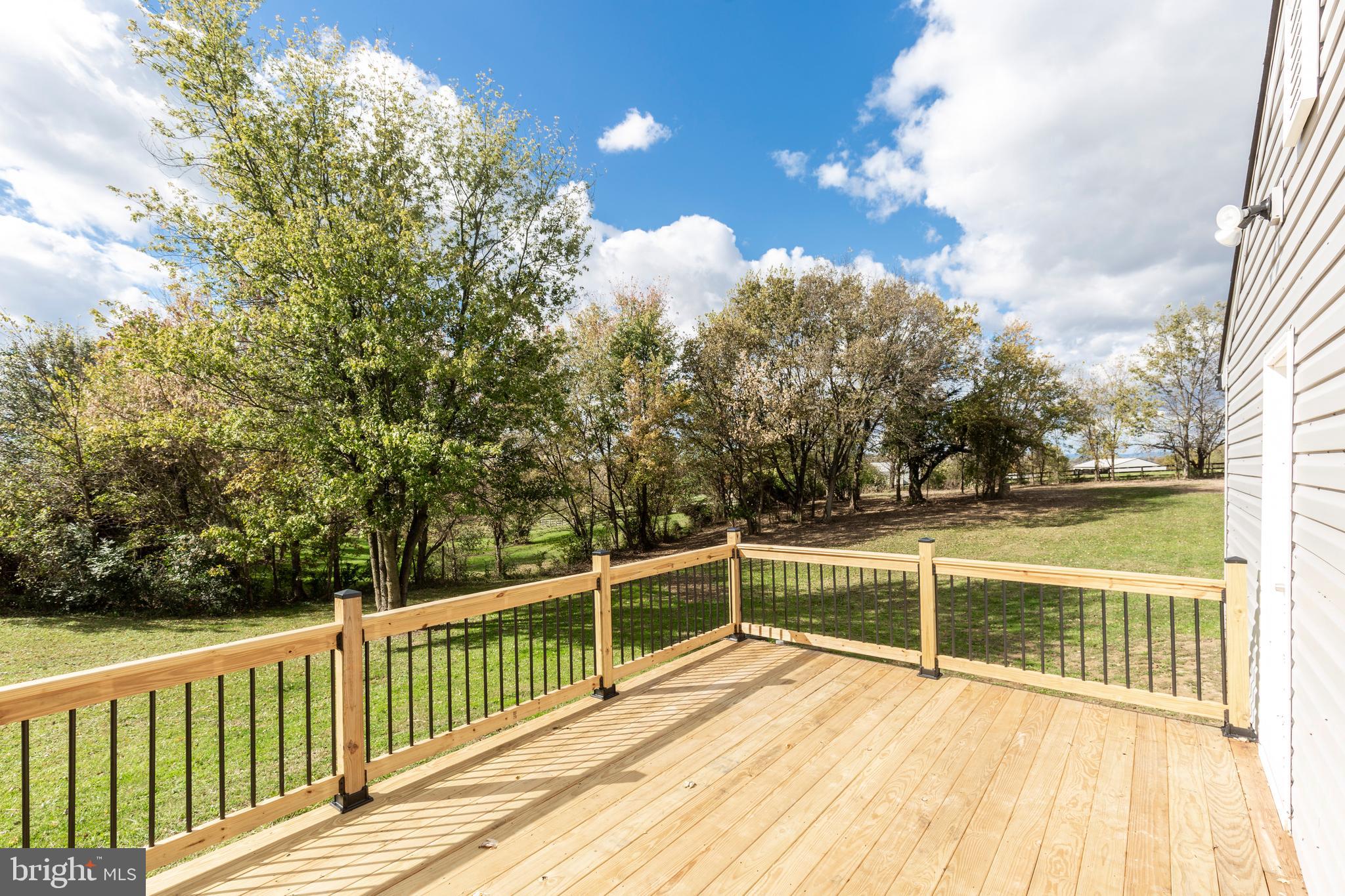 1030 Mckinstrys Mill Road Union Bridge, MD 21791 - Photo 27 of 43 a view of a balcony with floor to ceiling window and wooden fence